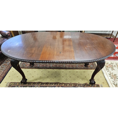 589 - An early 20th Century Mahogany Dining Table of neat proportions with rope edge outline and carved ba... 