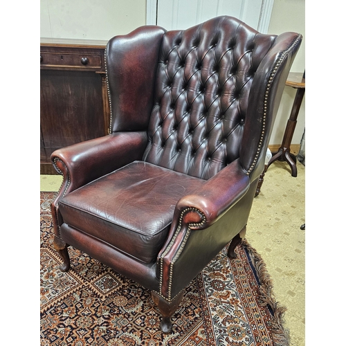 595 - A lovely burgundy Leather Wingback Chair with deep buttoned upholstered back and cabriole supports. ... 