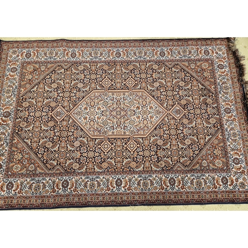 598 - A Persian burgundy ground Carpet with repeating borders and central medallion design 287 x 185 cms a... 