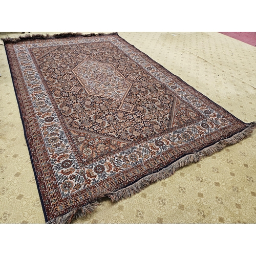 598 - A Persian burgundy ground Carpet with repeating borders and central medallion design 287 x 185 cms a... 