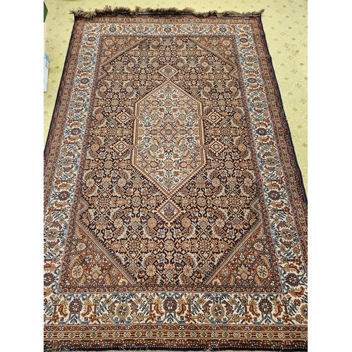 598 - A Persian burgundy ground Carpet with repeating borders and central medallion design 287 x 185 cms a... 