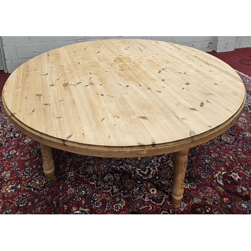 930 - An extremely large stripped Pine circular Dining Table on turned supports. D 180 x H 76 cm approx.