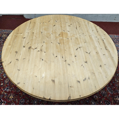 930 - An extremely large stripped Pine circular Dining Table on turned supports. D 180 x H 76 cm approx.