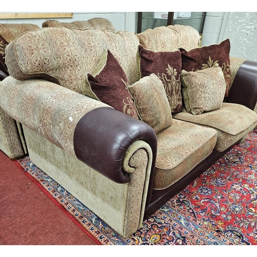 1414 - A burgundy and cream ground Couch with leather arm savers and a large quantity of dab cushions.
SH 4... 