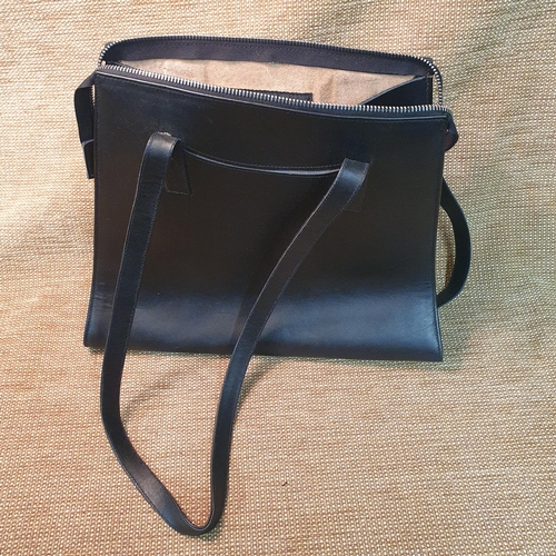 131 - A group of three Ladies Leather Hand Bags to include Designer bag by Flavell & Flavell, Nicole Farhi... 