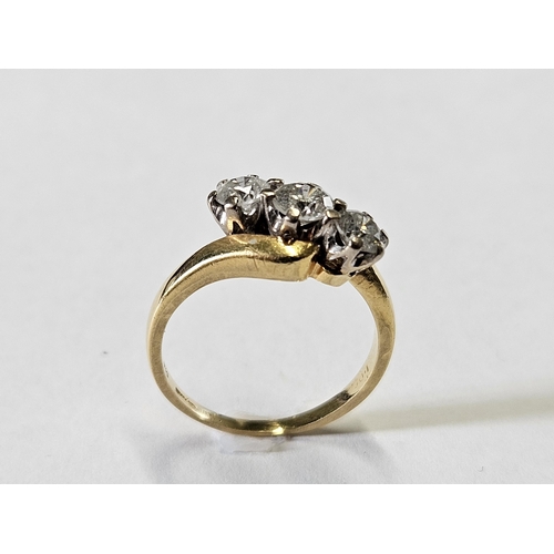 307 - An 18ct Gold and Diamond three stone Ring, size M.