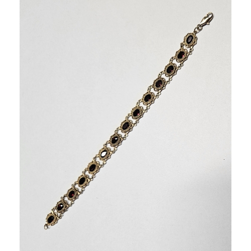 332 - A beautiful 9ct Gold and Garnet Bracelet with pierced outline.