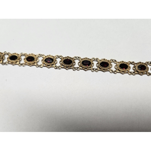 332 - A beautiful 9ct Gold and Garnet Bracelet with pierced outline.