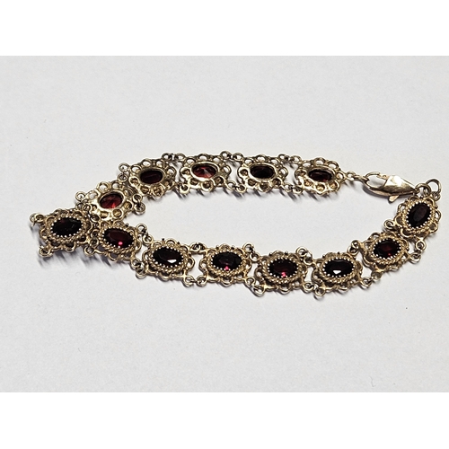 332 - A beautiful 9ct Gold and Garnet Bracelet with pierced outline.