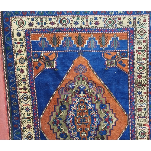 704 - A good blue ground Persian Rug with central medallion design and multi borders.
L 175 x W 118 cm app... 