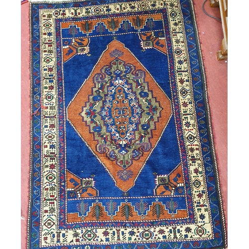 704 - A good blue ground Persian Rug with central medallion design and multi borders.
L 175 x W 118 cm app... 