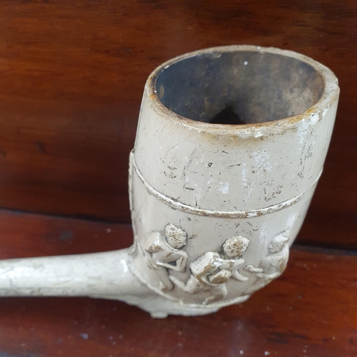 759 - A rare extra large 19th Century clay Pipe decorated with footballing Figures, the bowl supported wit... 