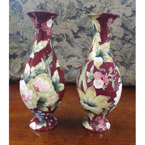 761 - In the style of Moorcroft a good pair of Old Tupton Ware vases with red ground. 
D 11 x H 25 cm appr... 