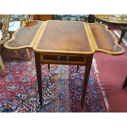 977 - A reproduction Mahogany and Veneered Dropleaf Table on square tapered supports and brass castors. 77... 