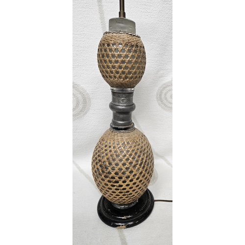 187 - An unusual early 20th Century double gourd Lamp with canework detail. H 53 cm approx.