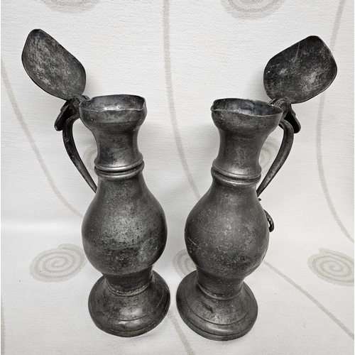 243 - A very unusual 18th  early 19th Century large pewter Water Jugs with hinged lift up Lids. 46 cm tall... 