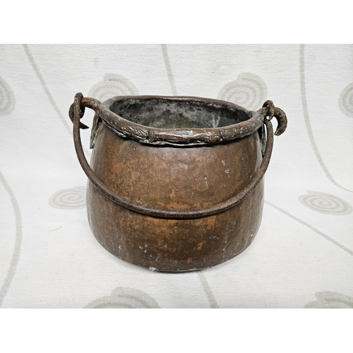 258 - An 18th Century Copper Cauldron with wrought iron handle. 39 diam. x 25h cms approx.