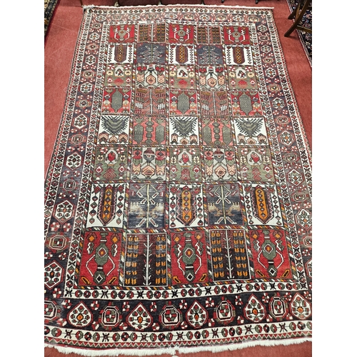 706 - A vintage Persian Bakiar village Carpet with a traditional Persian panel design. 320 x 200 cm approx... 