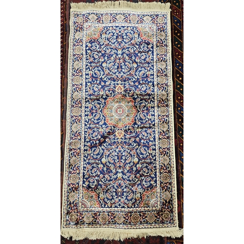 713 - A deep blue ground full pile Cashmere style Rug with a traditional medallion design.
L 149 x W 68 cm... 