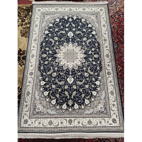 718 - A full pile hand woven Iranian Rug with an embossed floral medallion design.
L 240 x W 152 cm approx... 