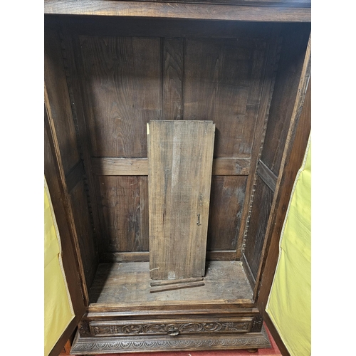 26 - A Fabulous Oak two door Cabinet/Wardrobe with highly carved twin doors backed with pleated material.... 