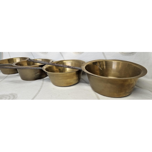 40 - A lovely set of four large 19th Century Brass long handled graduated Saucepans. 31 cm approx.