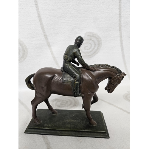 71 - A well moulded figure of a race Horse with jockey up. With imprint mark.