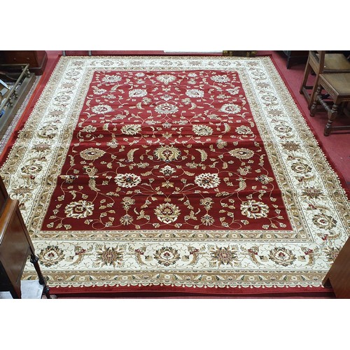 723 - A large Red ground full pile Turkish Carpet with an all over floral pattern design and surrounding b... 