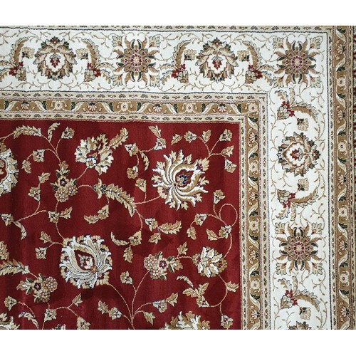 723 - A large Red ground full pile Turkish Carpet with an all over floral pattern design and surrounding b... 