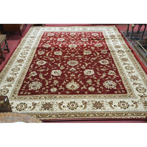 723 - A large Red ground full pile Turkish Carpet with an all over floral pattern design and surrounding b... 