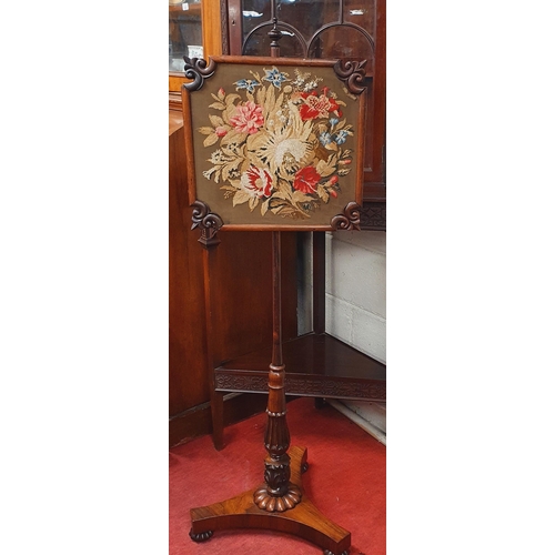 894 - A Regency Rosewood Pole Screen with tapestry upholstered centre. H 138 cm approx.