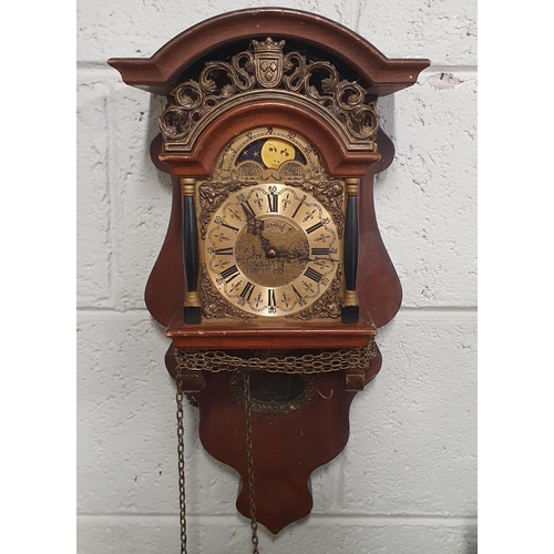 898 - Two wall mounted chain driven Clocks with weights.