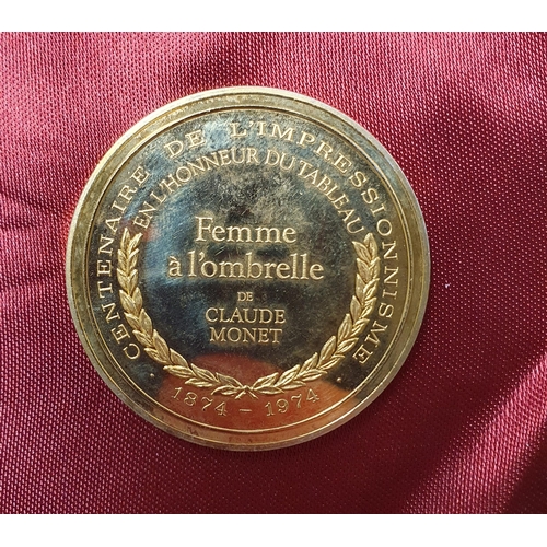 1020 - A Silver Gilt Commemorative Medallion, Femme a l'ombrelle de Claude Monet weighing 31 grams.