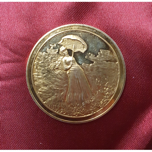 1020 - A Silver Gilt Commemorative Medallion, Femme a l'ombrelle de Claude Monet weighing 31 grams.