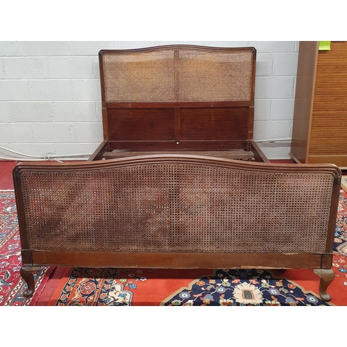 1451 - A late 19th early 20th Century Mahogany framed Bed with canework detail and moulded showframe outlin... 