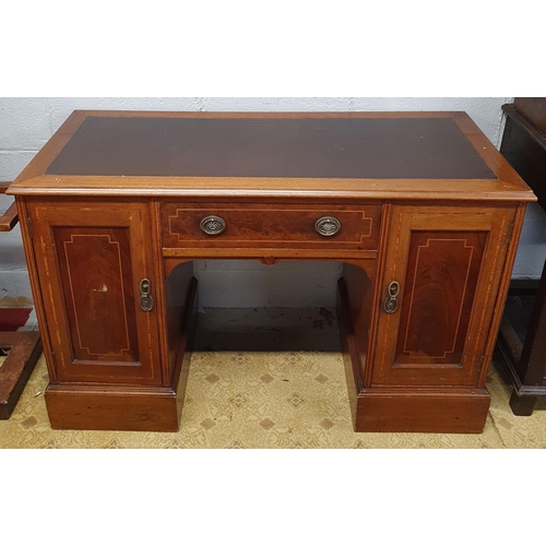 86 - An Edwardian Mahogany inlaid Kneehole Desk with twin panel doors flanking a central single frieze dr... 