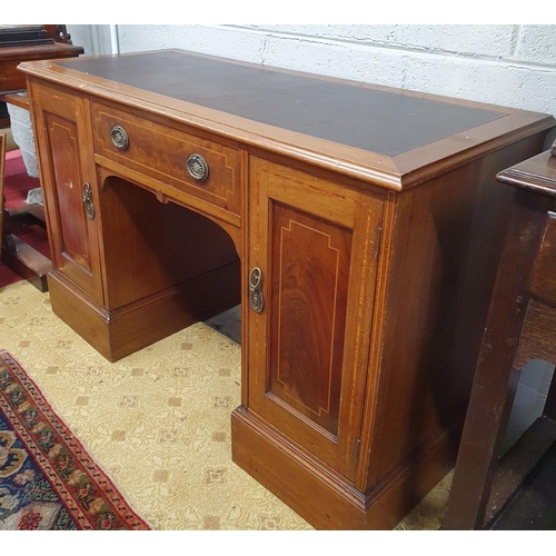 86 - An Edwardian Mahogany inlaid Kneehole Desk with twin panel doors flanking a central single frieze dr... 