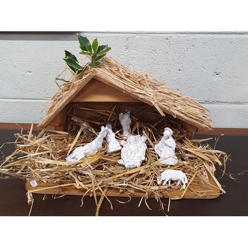 87 - A Nativity Crib along with Figures depicting a manger scene. 42 x 22 x H 26 cm approx.