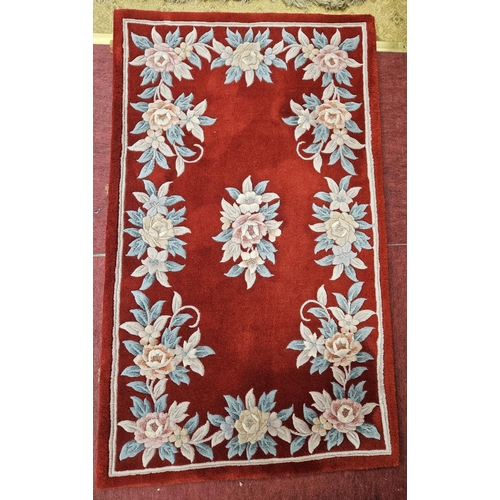 612 - A good pair of red ground Chinese Rugs with floral design. 152 x 90 cm approx.