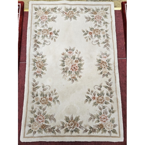 617 - A cream ground Chinese Rug with floral design. 119 x 180 cm approx.