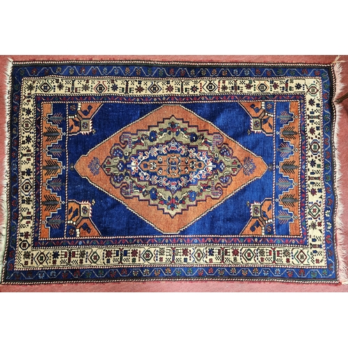 704 - A good blue ground Persian Rug with central medallion design and multi borders.
L 175 x W 118 cm app... 