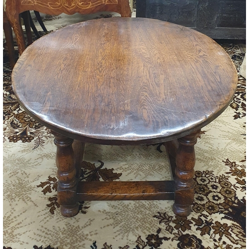 875 - A large heavy oval Oak Coffee Table on turned supports and stretcher base. 122 x 87 x H 48 cm approx... 