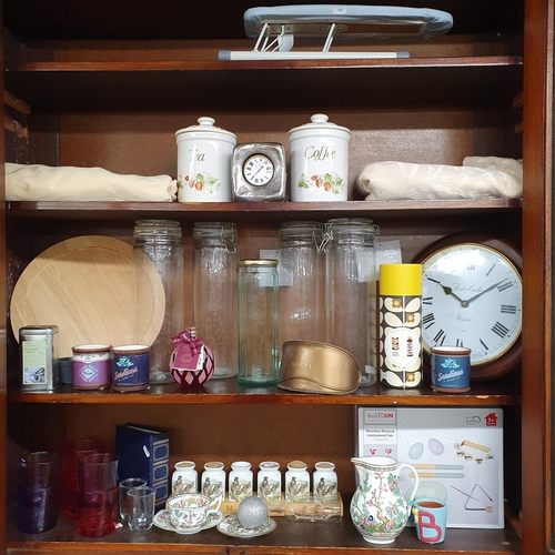 879 - A large quantity of Kitchenalia on three shelves.