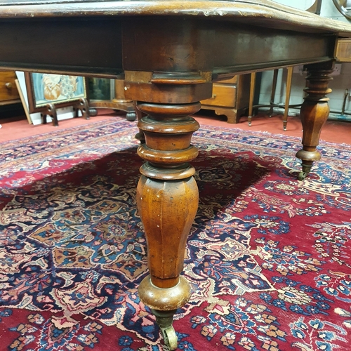 692 - A Victorian Mahogany Dining Table on tulip and octagonal supports with brass castors.H 73 x L 159 x ... 