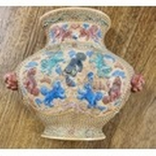 407 - A rare Chinese relief moulded iron red wall Vase with mythical beasts under a demi lune neck and a s... 