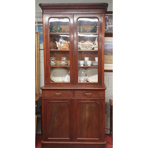 744 - Of good quality. A 19th Century Mahogany two door Bookcase with twin panel doors and twin frieze dra... 