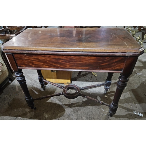 615 - A late 19th Century Mahogany fold over Card Table with stretcher base and turned supports. Held in O... 