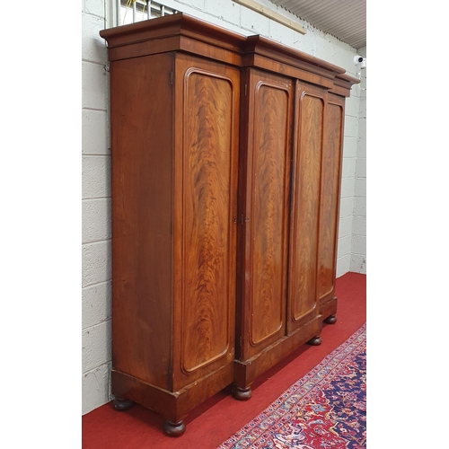 182 - A large 19th Century four door breakfront Wardrobe with flame grain panel doors.
229 x 60 x H 199 cm... 