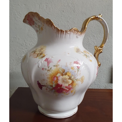 20 - A 19th Century floral pattern Jug along with a large stoneware Ewer. TB 40 cm approx.