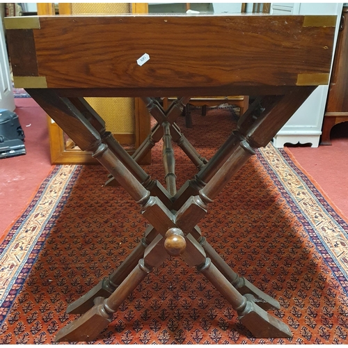 23 - A 20th Century Rosewood Desk with triple drawer frieze on x framed stretcher base and brass military... 